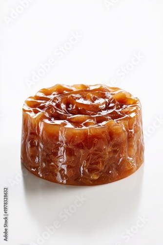 A single round dessert with a textured top resembling a flower on a white background