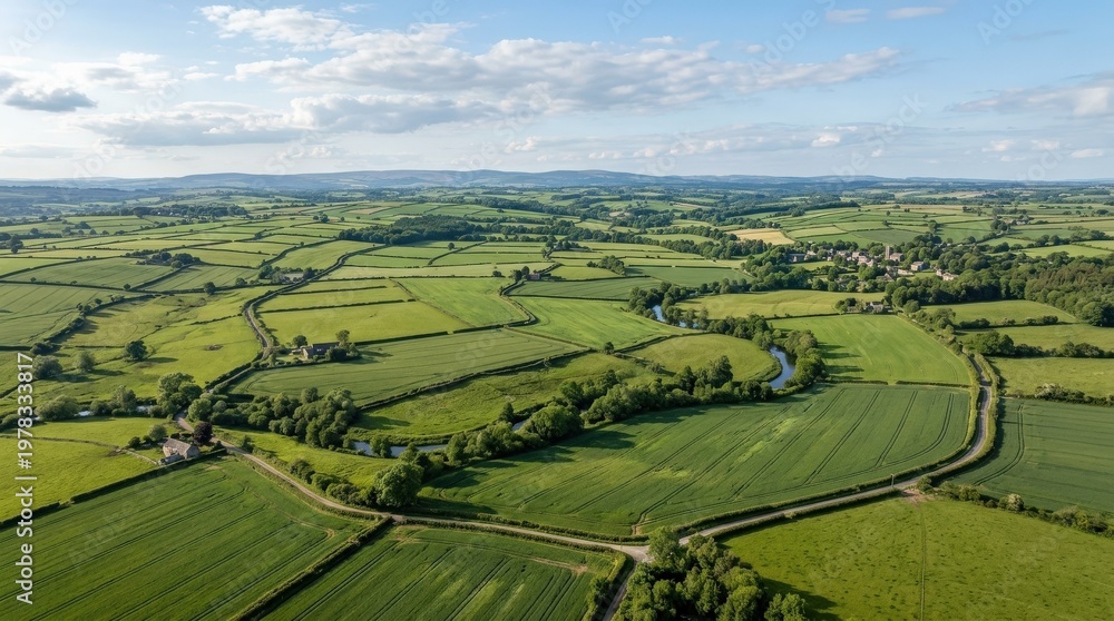 Fototapeta premium An aerial view of a landscape with vast green fields, open rural geometry and calm natural space beneath soft sunlight, ultra-realistic, no logos.