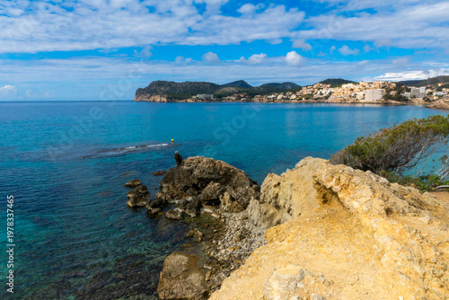 Panoramic view of turquoise bay and rocky coastline in Peguera Mallorca with clear water 