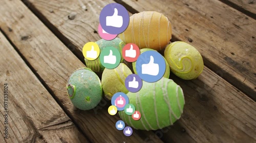 Painted eggs resting on wood plank, reaction icons appearing from bottom showing social engagement