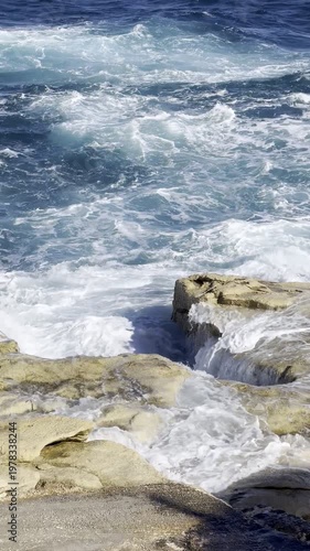 Rough ocean waves crashing on rocky coast