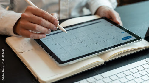 A businesswoman's hand uses a pen for writing on a notebook and signing a document during a professional office meeting at a desk