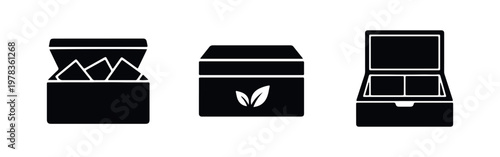 Minimalist black icon set of tea boxes and chests, including open designs with teabags and organic leaf packaging, isolated on white.