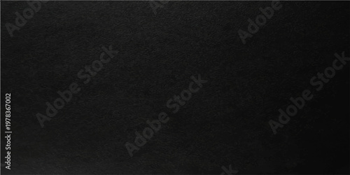 An enigmatic, solid, black surface, revealing the nuances of a unique, textured, and moody appearance.