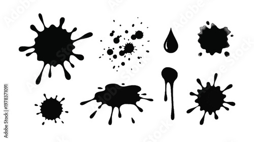 Various black ink splashes on a white background showing different shapes and sizes during a creative project in a studio
