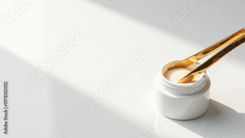 A close-up shot of a bottle of liquid with a gold spoon on top, great for product or food photography