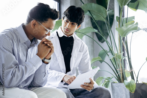 Fotografie Doctor consulting male patient, explaining medical information, providing empath