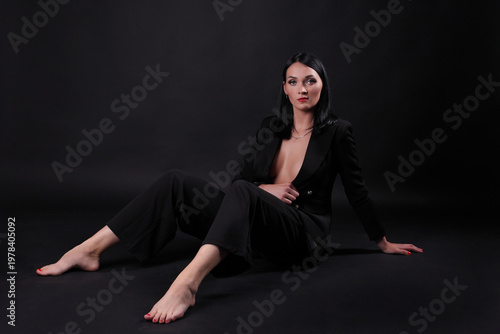 Obraz na płótnie Sexy fashion woman in black suit on dark background