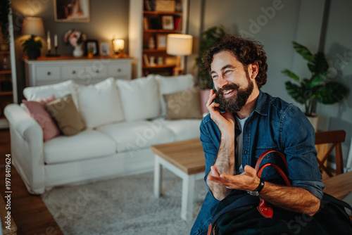 Mature man talking on phone arriving home