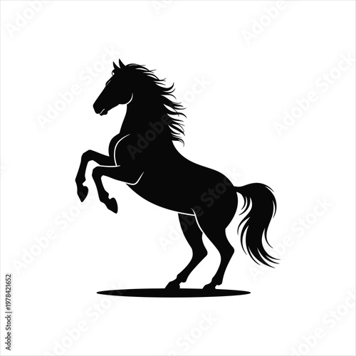 Majestic silhouette of a powerful black horse rearing up on its hind legs with flowing mane and tail