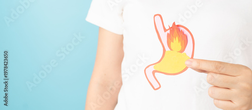 Woman suffering from stomach burn with acid reflux. Gastroesophageal reflux disease (GERD) or heartburn symptoms. Gastrointestinal system disease and digestive problems.