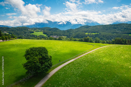 A breathtaking alpine landscape with green meadows, pine forests and majestic mountain peaks on background near Bolzano, South Tyrol province, Italy.
