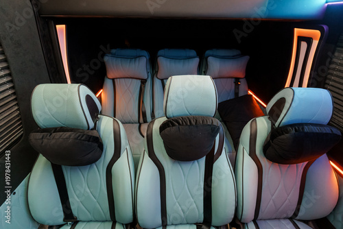 Luxury Passenger Seating Interior with Light Blue Leather and Modern Ambient Orange Lighting