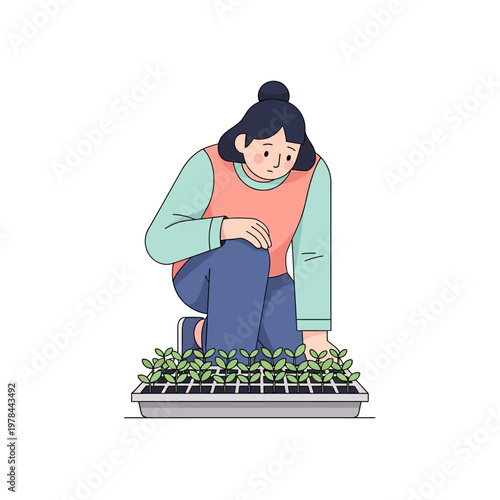 Woman tending to seedlings in a tray.