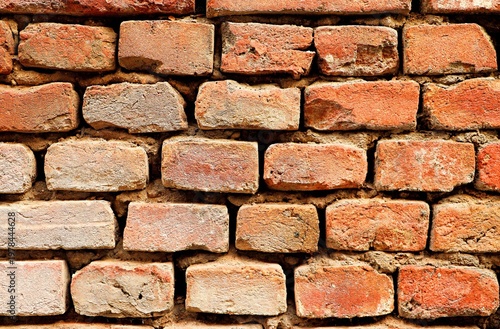 Background, texture of an old brick wall, seams between bricks with weathered cement