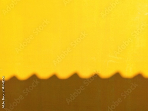 Minimalist Abstract Background of Sun Light and Geometric Roof Shadow on Bright Yellow Texture Wall Surface with Copy Space