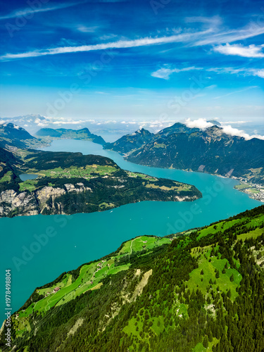 Aerial view of the dazzling turquoise waters of Lake Lucerne winding through verdant hillsides, a picturesque scene of natural beauty, Lucerne, Switzerland.