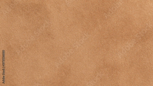 A close up view of textured light brown suede fabric background