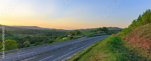 Long road with a beautiful sunset in the background