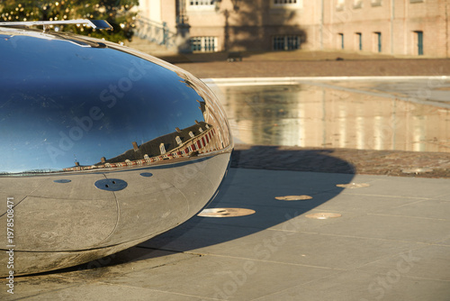 Sunlight gleams on polished chrome, reflecting a warm, historic facade.
