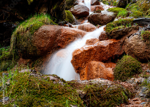 Photos photo of a noisy spring with a large amount of water, which precipitates iron spring lime