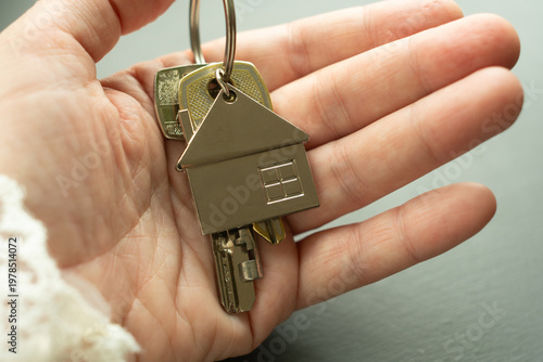 Hand with bunch of keys to new house or apartment. Moving to new apartment, buying or renting real estate