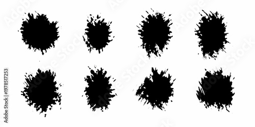Abstract black ink splatters arranged in a grid pattern on white