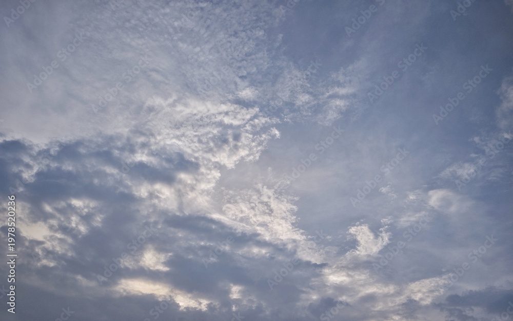 Fototapeta premium Dramatic cloudy sky with soft sunlight, natural atmosphere background, moody weather scene, peaceful outdoor environment.