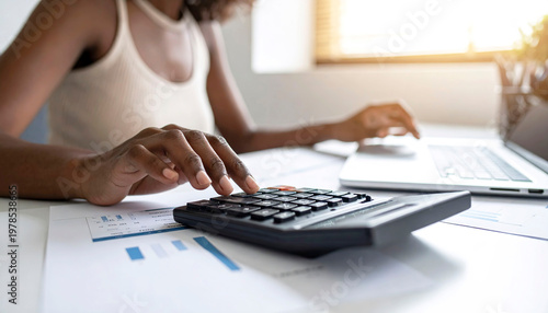 Close-up of woman handling finances with calculator, tracking costs, personal accounting scene
