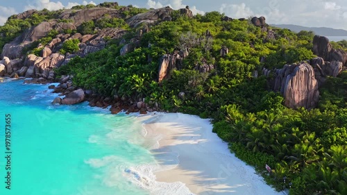 Wallpaper Mural Turquoise ocean waves wash the white sand beach in the Seychelles. Island aerial captures jungle trees and granite boulders bordering the coast of the Seychelles Torontodigital.ca