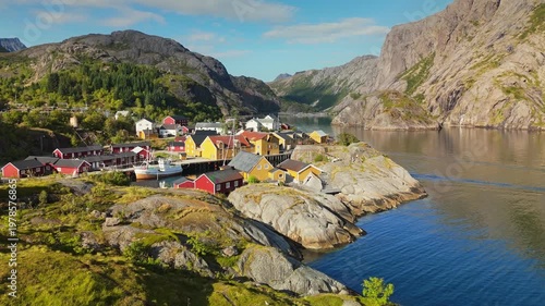 Wallpaper Mural Traditional red and yellow cabins stand in the Nusfjord fishing village of the Lofoten Islands, Norway. Drone aerial reveals steep mountains surrounding the fjord of Nusfjord, Norway Torontodigital.ca