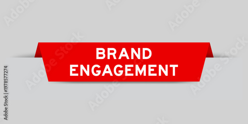 Red color inserted label with word brand engagement on gray background