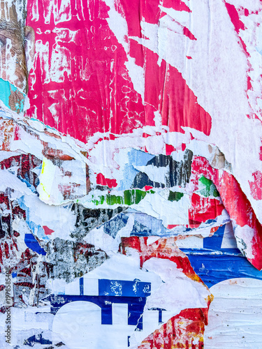 Layers of old colorful posters on wall damaged by time for your grunge style design