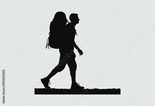 A silhouette of a lone male hiker carrying a large backpack walking across a plain landscape area