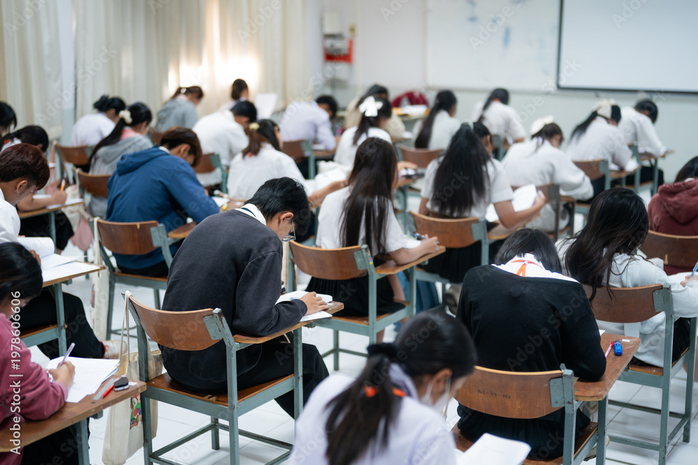 Obraz premium Students Taking Exam in Classroom Focused on Writing