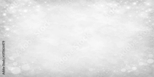 A grunge white christmas background features a delicate pattern of frozen snowflakes and frost texture that captures the cold light of a winter day on a weathered paper surface