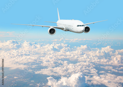 White passenger airplane flying in the sky amazing clouds in the background - Travel by air transport