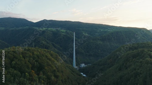 This aerial view shows a tall industrial chimney at a former coal plant site in Trbovlje, marking the shift from fossil fuels to renewables.