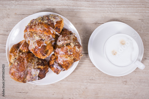 Croissants from polish city Poznan baked according to traditional recipe with poppy seed filing and cup of coffee