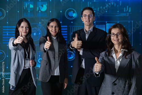 Four smiling professionals stand in front of a digital data background, giving a thumbs-up, symbolizing success, teamwork, and positive business outcomes.