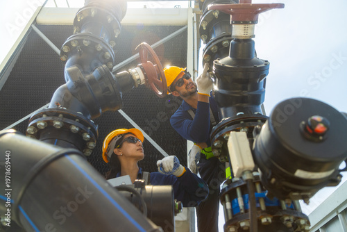 Industrial Technicians Adjusting Large Pipeline Valve