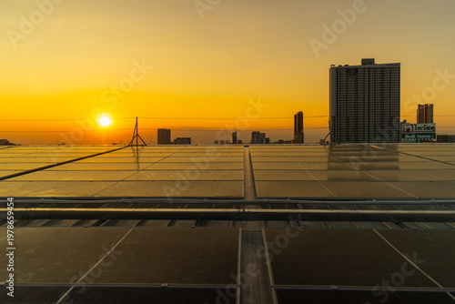 Rooftop Solar Panels at City Sunset Skyline