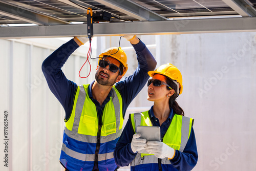Solar Technicians Installing Microinverter Under Panels