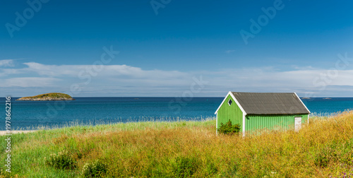 Green boathouse on the coast in Scandinavia