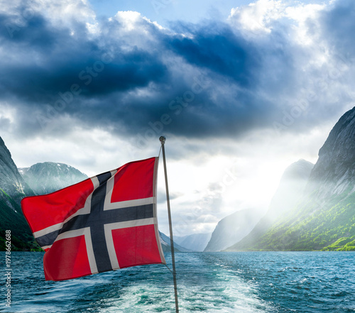 Norwegian ship flag on a ship in a fjord in Norway