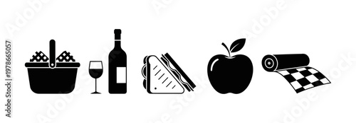 Picnic essentials a basket filled with fruit, a bottle of wine with a glass, a sandwich, an apple, and a checkered blanket for outdoor enjoyment