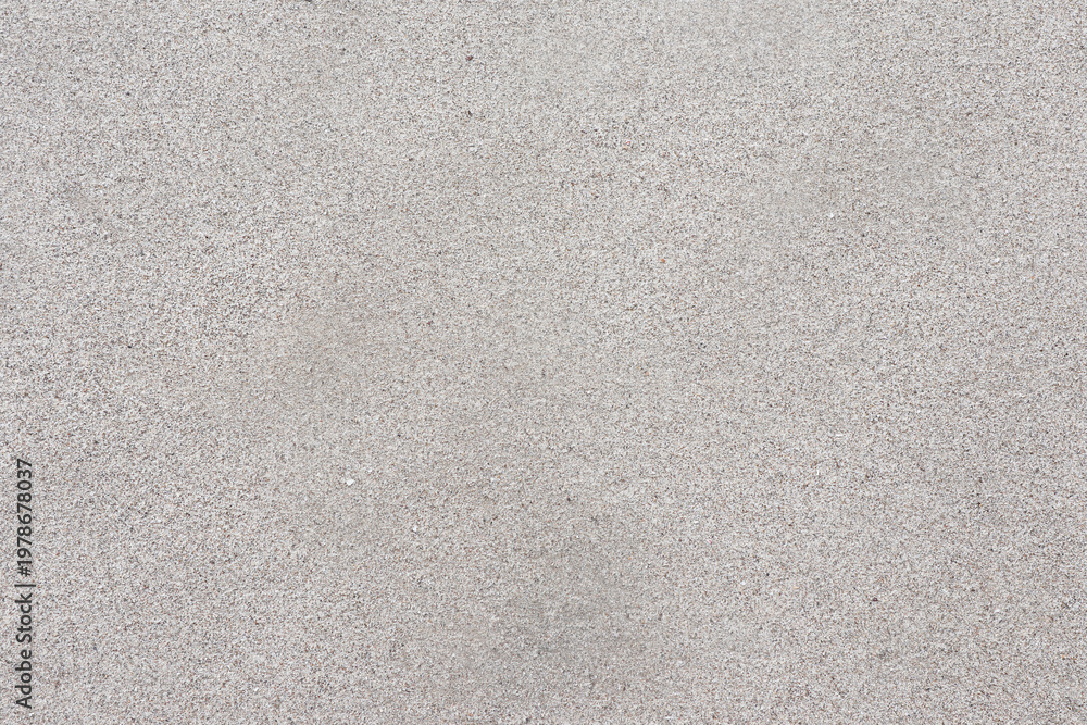 Fototapeta premium Top-down view of clean and fine-grained beach sand. Neutral beige texture offers a minimalist aesthetic.