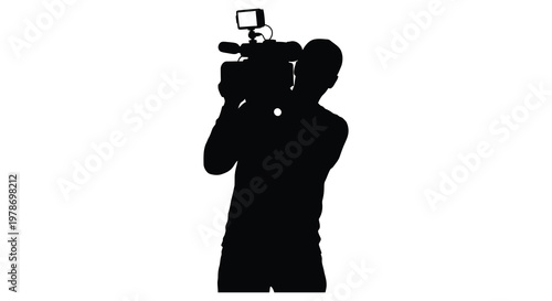 A cameraman operates equipment capturing footage in stark black silhouette