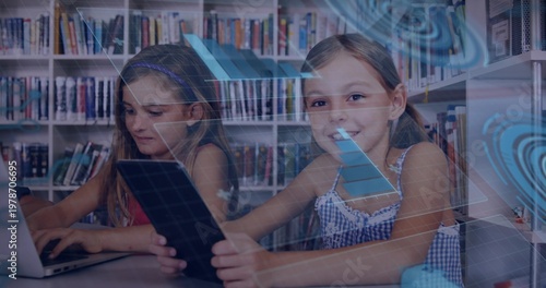 Typing on laptop left girl wearing dress, right girl holding tablet at library shelves, HUD overlay