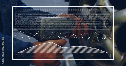 Operating air wrench, mechanic in dark-blue jacket tightening lug nut on wheel at shop, with HUD